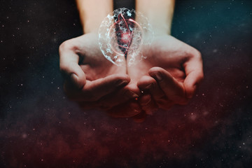 Human hand holding cell dividing and atom. Nebula dust. Mixed media.