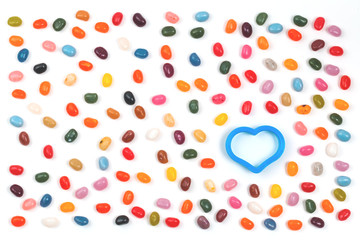 Jelly bean sweets frame background with festive heart. Love and St Valentines celebration concept flat lay