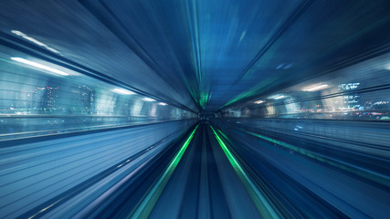 Fototapeta na wymiar Motion blur of Automatic train moving inside tunnel in Tokyo, Japan.