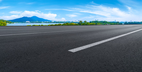 Empty asphalt road square and natural landscape under the blue sky