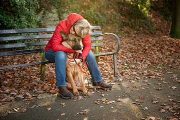 Mature woman with Alsatian dog In the park in winter 