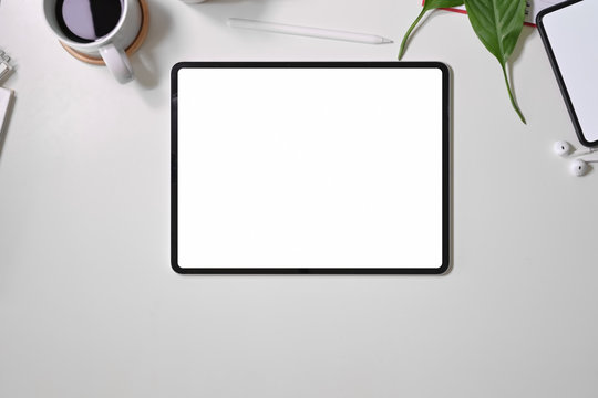 Top view digital display graphics tablet on white workspace desk table