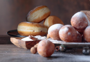 Sweet donuts with cinnamon sticks powdered with sugar.