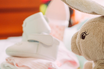 babyshower gifts, shoes, puppets, clothes, feeding bottle, with modern chic style, standing on...