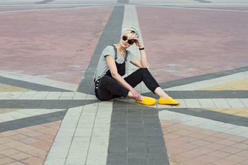 woman in sunglasses sitting on the town square