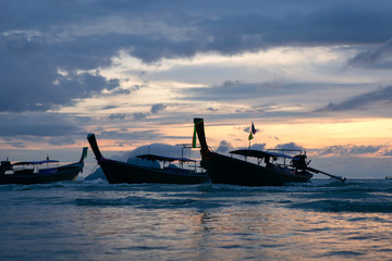 Traditional thai boats at sunset beach.