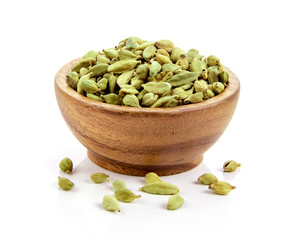 cardamom in wood bowl isolated on white background