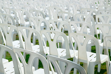White Plastic Chairs Rows in the Lawn in Outdoor Event