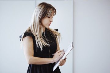 Fototapeta premium Business woman in a black dress.
