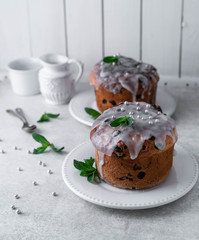 Easter cake on a white plate, light composition, white wooden background