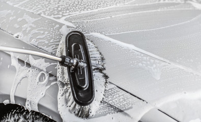 Detail on brush wet from shampoo, cleaning in carwash.