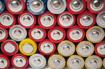 closeup of red and silver aa alkaline batteries stack on full frame