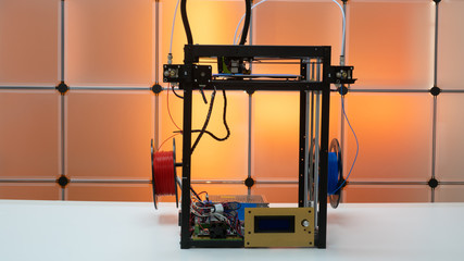 3d printer and plastic filament on color background