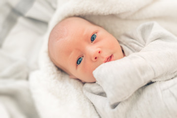 Portrait of a baby girl close-up. Baby in the crib.
