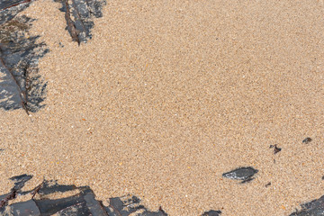 stone, rocks frame on beach sand background.