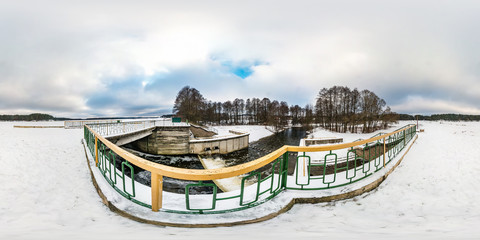 full seamless spherical winter panorama 360 degrees angle view near the dam of wide lake. 360 panorama in equirectangular projection, ready VR AR virtual reality content