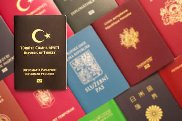 Diplomatic biometric passport of Turkey on a blurred background of various documents of many countries of the world