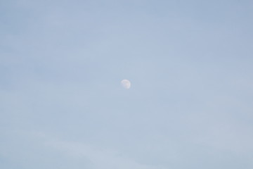 moon on blue sky in daytime .