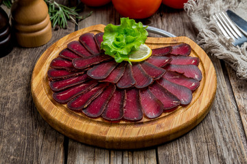 Dried sliced basturma on the Board