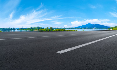 Fototapeta premium Empty asphalt road square and natural landscape under the blue sky