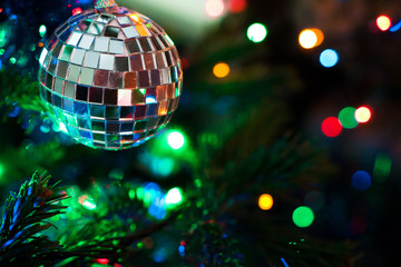 Fototapeta na wymiar Mirror ball on decorated Chrismas Tree,Pine, New year, chrismas lighs closeup