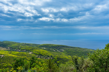 Greece, Zakynthos, Thunderstorm atmosphere over green mountains and endless blue sea