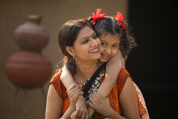 portrait of loving Indian mother and daughter at village