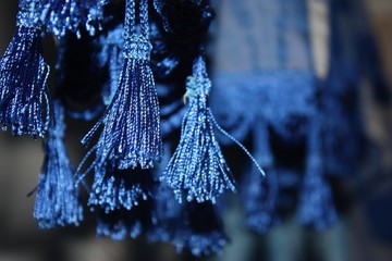 Knitted, dark blue bells close-up on a blue background