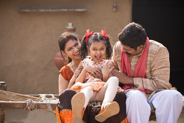 Loving Indian parents and daughter at village