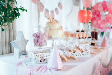 Pink candy bar for first birthday. Sweet table and big cake for first birthday