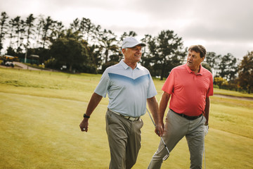 Senior golfers walking to the next hole