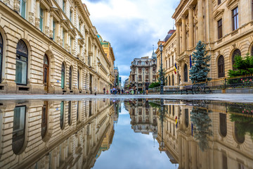 Bucharest, Romania - July 6th 2018 - The old town of Bucharest seen through a water reflection with...
