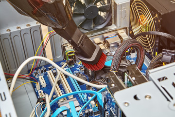 Vacuum cleaner cleans motherboard and cables of personal computer.