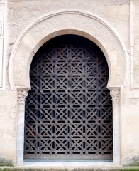 Iron gate with patterns and traditional arabic motifs of the famous Mezquita, Mosque-Cathedral of Cordoba, Spain