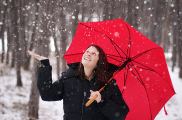 Woman With A Red Umbrella Enjoying The Snow
