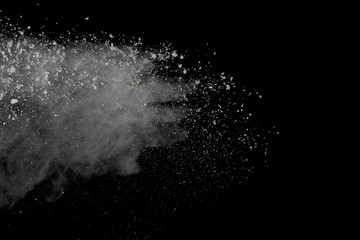 White powder explosion isolated on black background.
