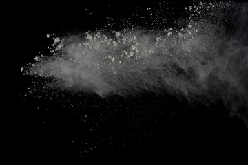 White powder explosion isolated on black background.