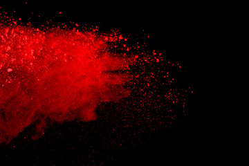 Red powder explosion isolated on black background.