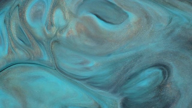 Colorful paint with silver particles organically moves in the liquid