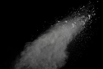 White powder explosion isolated on black background.