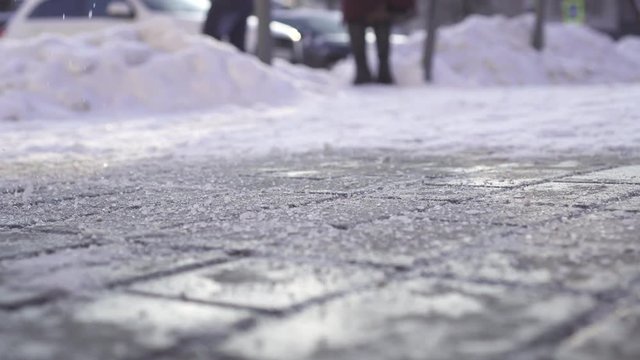 Anti icing reagent falls on ice in winter