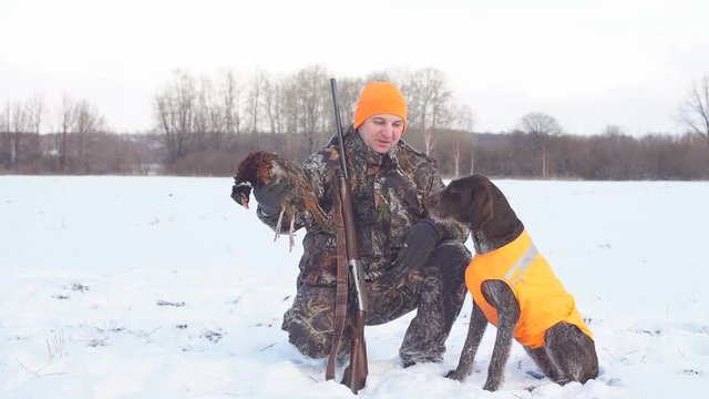 Positive hunter with dogs during the rest on winter hunting. hobby, interest