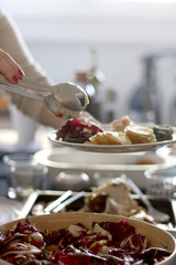 Bowl of bittersweet salad with oranrges, radicchio, ricotta cheese and pomegranate seeds. Table served for family and friends. Selective focus.