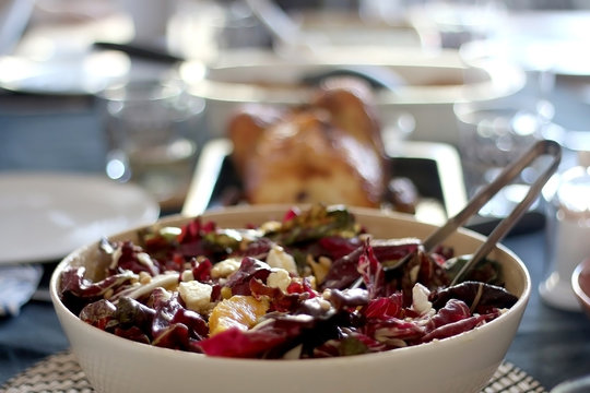 Bowl Of Bittersweet Salad With Oranrges, Radicchio, Ricotta Cheese And Pomegranate Seeds. Table Served For Family And Friends. Selective Focus.