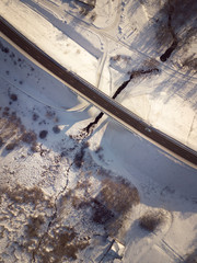 Aerial view on road and forest landscape in winter season.