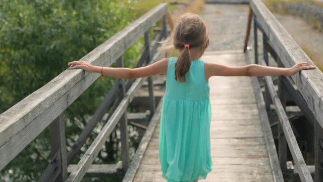 Little girl on an old bridge
