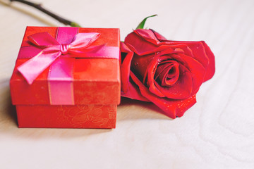 Кув gift box with red bow and rose red. Valentine's day concept.
