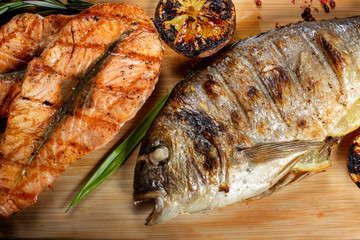 Fried fish and steaks on the board.