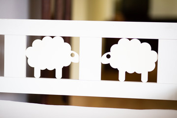 Adorable white sheep on a bed