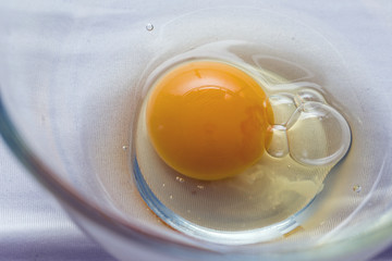View of an egg in a glass mixing bowl from above